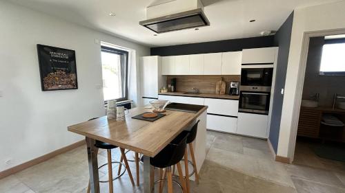 - une cuisine avec une table en bois dans une chambre dans l'établissement Maison Bretonne 5 chambres proche de la mer, à Saint-Potan