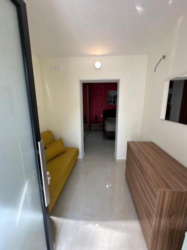 a living room with a yellow couch and a table at Marea in Bari