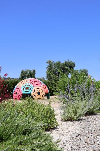 a sculpture of a turtle sitting in a garden at IL CARRUBO La dimora in Monopoli