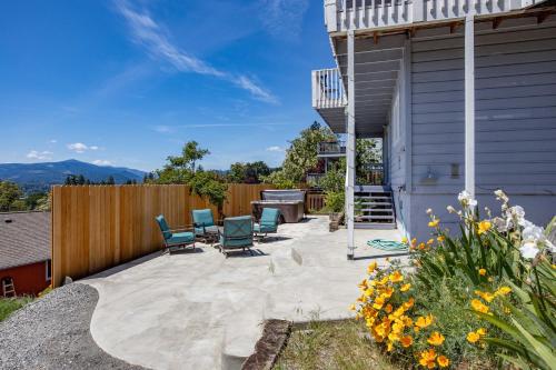 a patio with chairs and a grill and a fence at Grandview Get-A-Way home in White Salmon