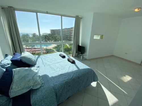 Ένα ή περισσότερα κρεβάτια σε δωμάτιο στο Apartamento en playa parguito