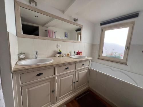 La salle de bains est pourvue de 2 lavabos, d'une baignoire et d'une fenêtre. dans l'établissement Maison Bellevue, 3 chambres, à Fayence