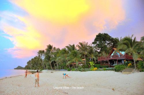 a group of people standing on a beach at Beachfront Oasis with Private Pool and Jacuzzi on Samuis Bang Por Beach in Ban Bang Po