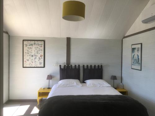 a bedroom with a large bed with two night stands at La Villa des Poètes in Nyons