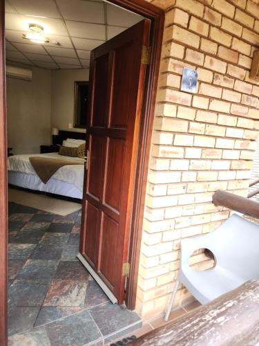 Ένα ή περισσότερα κρεβάτια σε δωμάτιο στο Goodnight Guest Lodge