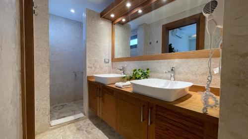 a bathroom with two sinks and a mirror at Nicole Residence in Las Terrenas