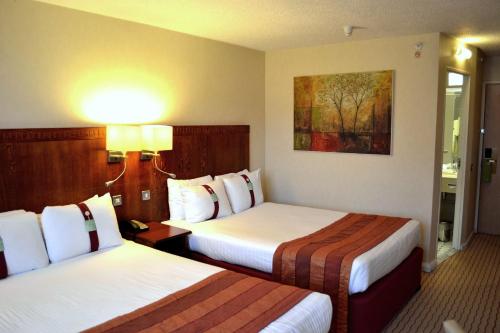 a hotel room with two beds in a room at Holiday Inn Northampton by IHG in Northampton
