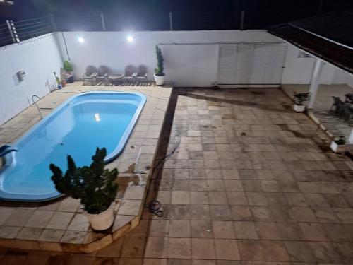 Una piscina con un cactus en un patio. en Casa com piscina a px a praia do Araçagy, en São Luís