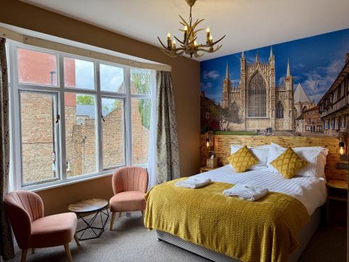 a bedroom with a large bed with a painting on the wall at The Crescent York in York