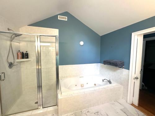 a bathroom with a shower and a bath tub at Blue Ruby Inn in Elizabeth City