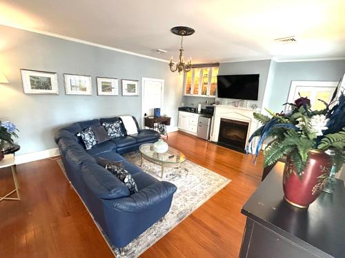 a living room with a blue couch and a tv at Blue Ruby Inn in Elizabeth City