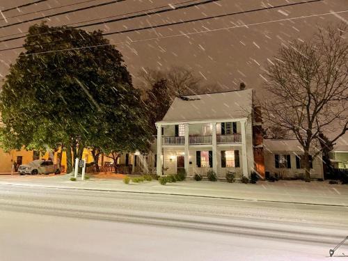 a white house on a street in the snow at Blue Ruby Inn in Elizabeth City