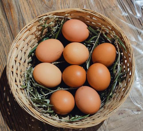 a basket filled with brown eggs on a table at Les jardins du Canal in Sainte-Eulalie