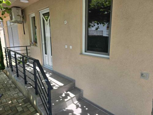 a house with stairs leading up to a door at Apartment Trifunovi 2 in Kochani