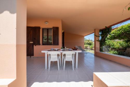 a patio with a white table and two chairs at 5 min dal mare - Ampia villa con Terrazza e Aria Condizionata in Costa Rei