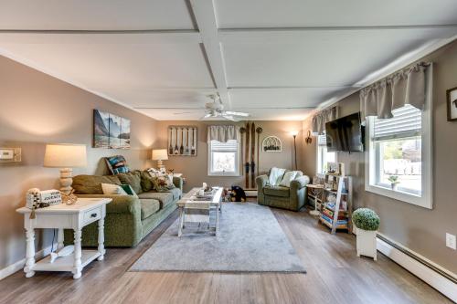 a living room with a couch and a table at Steps to Crystal Lake Spacious Retreat with Views in Barton