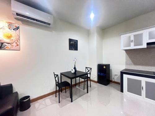 a living room with a table and chairs and a fireplace at Paradise Hotel & Apartment in Vientiane