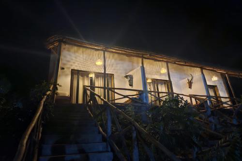 a stairway leading to a building at night at Akagera Park Inn in Akagera