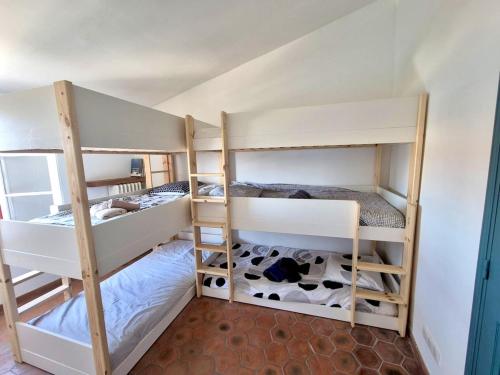 two bunk beds in a room with a cow at Fisherman's house in Port Grimaud in Grimaud