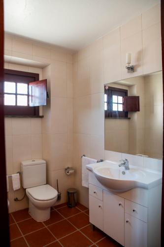 a bathroom with a toilet and a sink at Horta da Moura by WOT Signature in Monsaraz