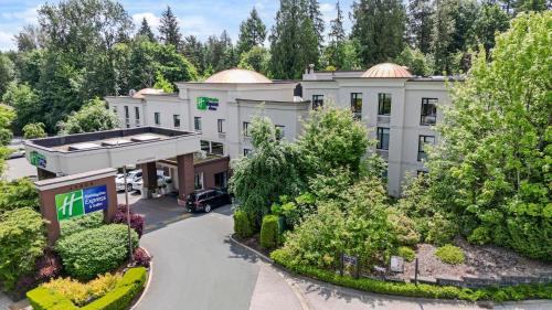 an aerial view of a hotel with a parking lot at Holiday Inn Express and Suites Surrey by IHG in Surrey