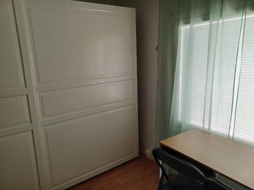 a room with a door and a table and a window at countryside next to center in Kemi