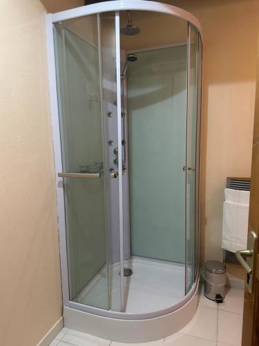a shower with a glass door in a bathroom at Celinatura in Préneron