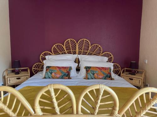 a bedroom with a large bed with two chairs at Celinatura in Préneron