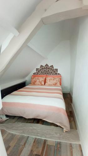 une chambre avec un lit dans un grenier dans l'établissement D-DAY's, à Bayeux