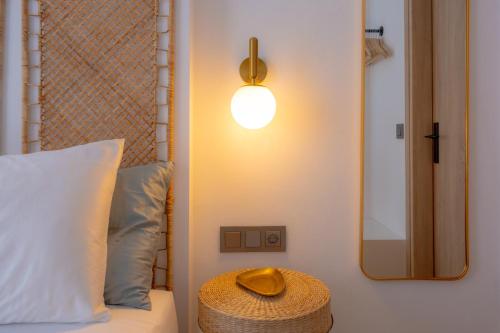 a hat sitting on a bed next to a mirror at TESORO Home & Spa in Plakias