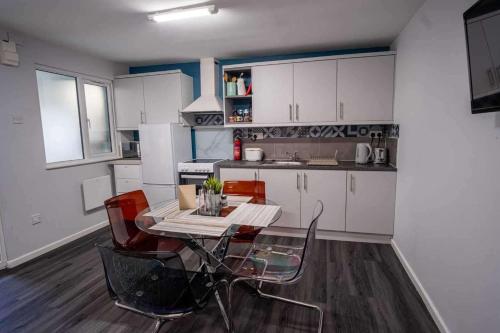 a kitchen with a table and chairs in a room at 1 Bed-Sleeps 4-Private Garden-Free Parking in St. Albans