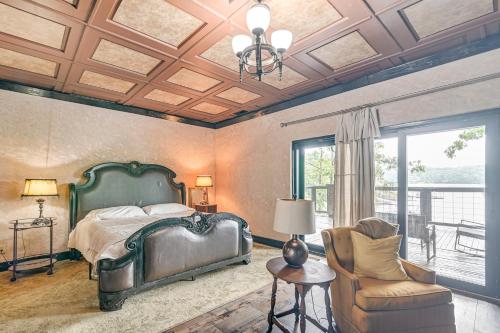 a bedroom with a bed and a chair at Upscale Getaway on Smith Lake with Boat Dock in Arley