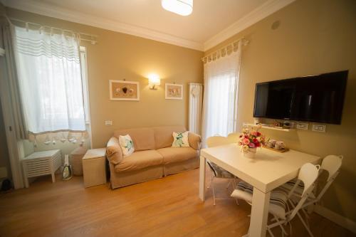 a living room with a couch and a table at Charming and Cozy House in Nettuno