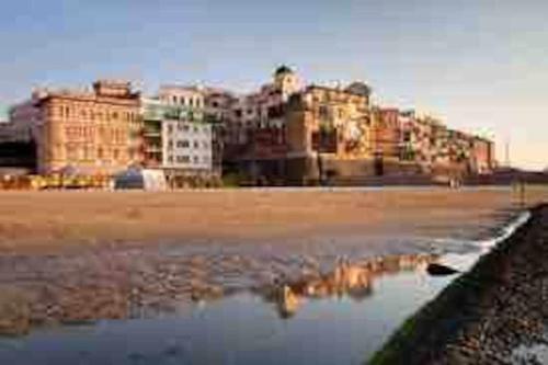 a view of a beach with buildings in the background at Charming and Cozy House in Nettuno