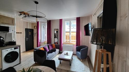 a living room with a couch and a table at Apartment in Downtown in Châteaubriant