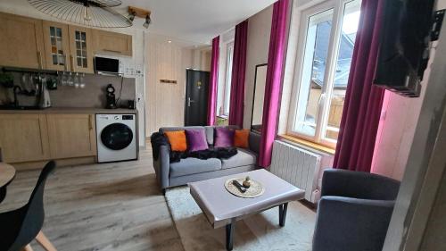 a living room with a couch and a table at Apartment in Downtown in Châteaubriant
