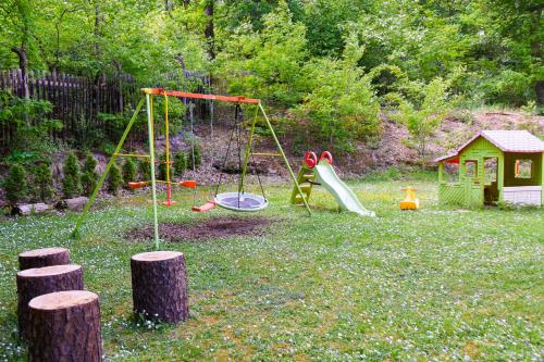 a playground with a slide and a swing at Parkhotel Zirndorf in Zirndorf