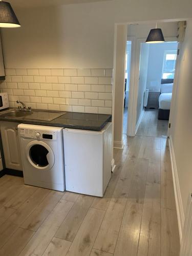 a kitchen with a washing machine in a room at St Patricks Avenue Apartment, H91A4W7 in Galway
