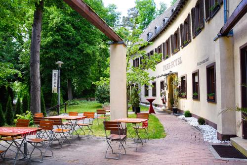 a group of tables and chairs outside of a building at Parkhotel Zirndorf in Zirndorf