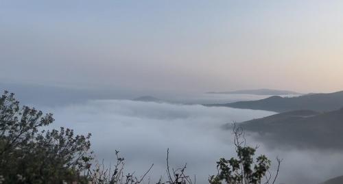 a view of a body of water with mountains in the background at Tranquil Retreat in Avathi