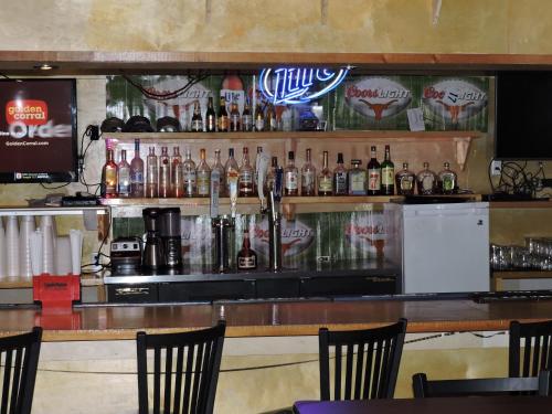 a bar with a lot of bottles of alcohol at El Dorado Suites in Crystal City