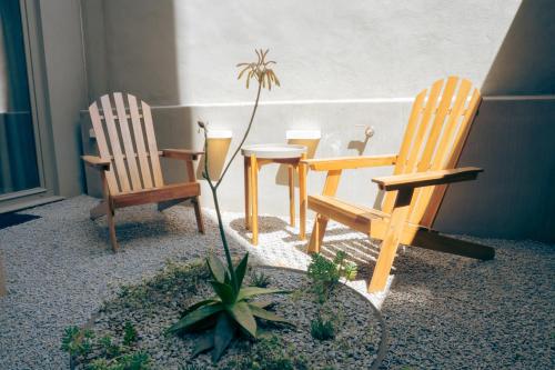 a patio with two chairs and a table and a plant at Domum 4 in Porto