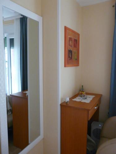 a living room with a mirror and a table at Apartment Valerija in Privlaka