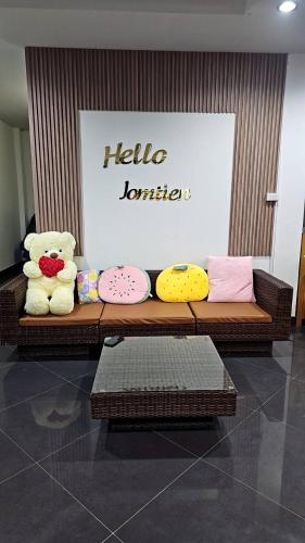 two teddy bears sitting on a bench in a store at Hello Jomtien in Jomtien Beach