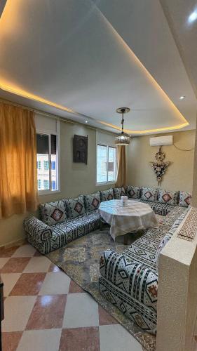a living room with a couch and a table at Fibule d'or in Tafraoute