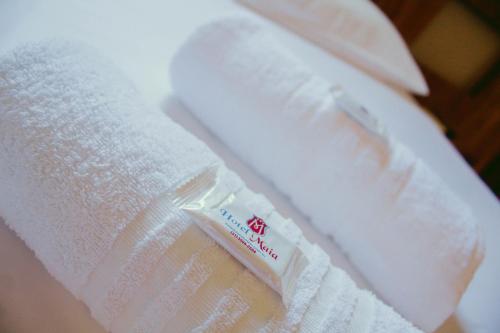 a roll of toilet paper sitting on top of a towel at Hotel Maia in Betim