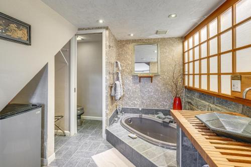 a bathroom with a tub and a sink at 9-Acre New River Retreat Near Radford University in Fairlawn