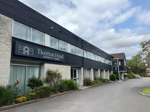 a building with a sign for a hotel at Tiverton Hotel Lounge & Venue in Tiverton