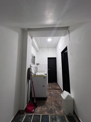 an empty hallway with a room with a refrigerator at ROCCO & ABBA APTOS AMOBLADOS in Pitalito