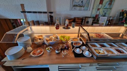 a table with a bunch of food on it at Berggasthof & Hotel Kranich in Eisfeld